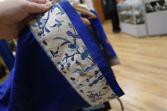 A Chinese silk embroidered robe c.1920s, embroidered with panels of birds and flowers on royal blue silk